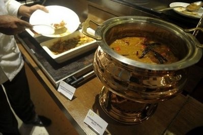 Indian hotel staff serve a dish of prawn and mango for guests during the Britain's Curry Festival in Kolkata. AFP photo Indian hotel staff serve a dish of prawn and mango for guests during the Britain's Curry Festival in Kolkata. AFP photo
