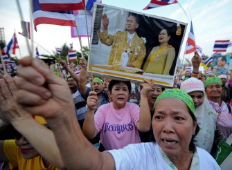 Thai Pro-government supporters wave national flags and hold portraits of the Thai King Bhumibol Adulyadej during a demonstration to counter anti-government "Red Shirt" protests in Bangkok on April 24, 2010. AFP photo Thai Pro-government supporters wave national flags and hold portraits of the Thai King Bhumibol Adulyadej during a demonstration to counter anti-government "Red Shirt" protests in Bangkok on April 24, 2010. AFP photo