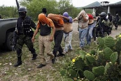 Soldiers escorts men freed after being kidnapped by drug hitmen at a ranch near the municipality of Sabinas Hidalgo, some 100 km away from Monterrey April 27, 2010. Soldiers escorts men freed after being kidnapped by drug hitmen at a ranch near the municipality of Sabinas Hidalgo, some 100 km away from Monterrey April 27, 2010.
