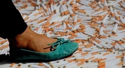 A woman walks over perspexencased 'cigarettes' in central Sydney. (AFP file) A woman walks over perspexencased 'cigarettes' in central Sydney. (AFP file)