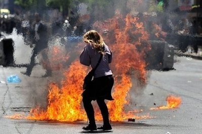 A demonstrator tries to avoid a petrol bomb during clashes between police and demonstrators in central Athens. A demonstrator tries to avoid a petrol bomb during clashes between police and demonstrators in central Athens.