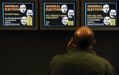 A customer looks at information screens displaying the odds on the result of this week's general election in a bookmakers in central London. AFP photo A customer looks at information screens displaying the odds on the result of this week's general election in a bookmakers in central London. AFP photo