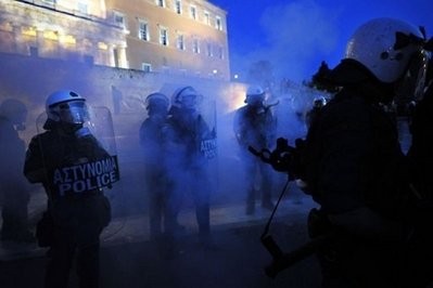 Riot police clash with demonstrators in Athens. World stock markets tumbled Friday as fears grew over the fallout from Greece's debt crisis, despite the approval by lawmakers in Athens of savage belt-tightening measures in the face of widespread unrest Riot police clash with demonstrators in Athens. World stock markets tumbled Friday as fears grew over the fallout from Greece's debt crisis, despite the approval by lawmakers in Athens of savage belt-tightening measures in the face of widespread unrest