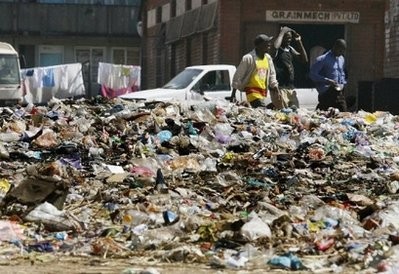 People are seen walking past a heap of rubbish in Harare's Mbare suburb. Local authorites have not collected the garbage over the past few months resulting in the increase of rats in the capital. People are seen walking past a heap of rubbish in Harare's Mbare suburb. Local authorites have not collected the garbage over the past few months resulting in the increase of rats in the capital.