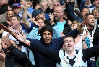 Chelsea supporters celebrate after their Premiership football match against Liverpool at Anfield in Liverpool on May 2, 2010. AFP PHOTO Chelsea supporters celebrate after their Premiership football match against Liverpool at Anfield in Liverpool on May 2, 2010. AFP PHOTO