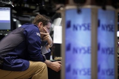Specialist Gregg Maloney works on the floor of the New York Stock Exchange, Friday, May 7, 2010, in New York Specialist Gregg Maloney works on the floor of the New York Stock Exchange, Friday, May 7, 2010, in New York