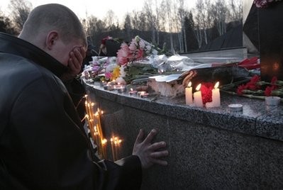 A man cries near a monument to the perished miners with candles lit in memory of the victims of the recent Raspadskaya mine explosions, in the city of Mezhdurechensk, in the west Siberian region of Kemerovo, Sunday, May 9, 2010. A man cries near a monument to the perished miners with candles lit in memory of the victims of the recent Raspadskaya mine explosions, in the city of Mezhdurechensk, in the west Siberian region of Kemerovo, Sunday, May 9, 2010.