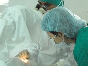 Doctors are conducting an eye surgery Doctors are conducting an eye surgery