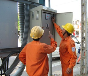 Electricians check a power panel in HCMC Electricians check a power panel in HCMC