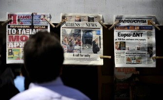 A man reads the newspapers front pages at a kiosk in downtown Athens, Greece, on May 10, 2010. AFP photo A man reads the newspapers front pages at a kiosk in downtown Athens, Greece, on May 10, 2010. AFP photo