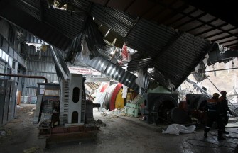 Emergency workers walk inside a building destroyed by an underground explosion at the Raspadskaya mine on May 10, 2010. AFP photo Emergency workers walk inside a building destroyed by an underground explosion at the Raspadskaya mine on May 10, 2010. AFP photo