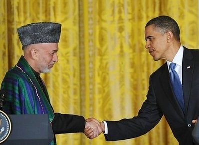 Afghan President Hamid Karzai (L) shakes hands with US President Barack Obama during a press conference in the East Room of the White House in Washington, DC. Afghan President Hamid Karzai (L) shakes hands with US President Barack Obama during a press conference in the East Room of the White House in Washington, DC.