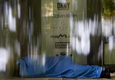 A homeless sleeps on the doorway of a shop in downtown Lisbon on April 29, 2010 A homeless sleeps on the doorway of a shop in downtown Lisbon on April 29, 2010