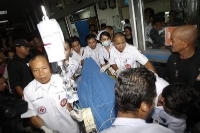Thai emergency medical staff rush Maj. Gen Khattiya Sawasdiphol, also known as Seh Daeng' to surgery after he was shot by a sniper Thursday, May 13, 2010, in Bangkok, Thailand Thai emergency medical staff rush Maj. Gen Khattiya Sawasdiphol, also known as Seh Daeng' to surgery after he was shot by a sniper Thursday, May 13, 2010, in Bangkok, Thailand