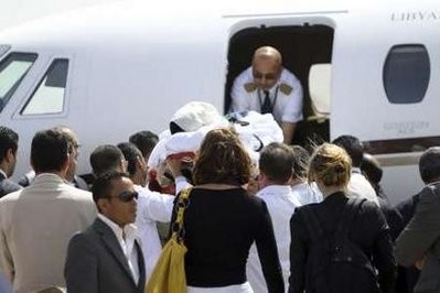 Nine-year old Dutch boy Ruben van Assouw (C) is transferred onboard a plane heading towards the Netherlands at Mitiga airport in Tripoli May 15, 2010 Nine-year old Dutch boy Ruben van Assouw (C) is transferred onboard a plane heading towards the Netherlands at Mitiga airport in Tripoli May 15, 2010
