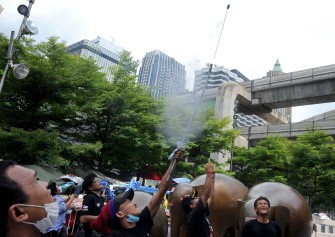 Thai "Red Shirt" anti-government protesters shoot a firework during demonstration in Bangkok on May 17, 2010. AFP photo Thai "Red Shirt" anti-government protesters shoot a firework during demonstration in Bangkok on May 17, 2010. AFP photo