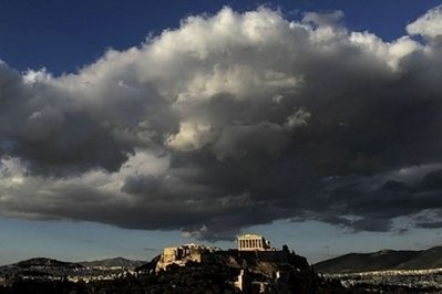 The ancient temple of Parthenon atop the Acropolis hill is illuminated by late evening sunlight in Athens The ancient temple of Parthenon atop the Acropolis hill is illuminated by late evening sunlight in Athens