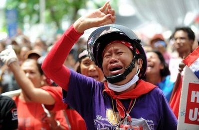 A Thai "Red Shirt" anti-government protester bursts into tears as their leaders announce their surrender inside the protesters' camp in downtown Bangkok. AFP photo A Thai "Red Shirt" anti-government protester bursts into tears as their leaders announce their surrender inside the protesters' camp in downtown Bangkok. AFP photo