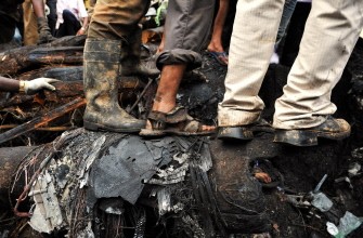 Rescue personnel and volunteers walk over wreckage at the crash site of an Air India Boeing 737-800 aircraft which crashed upon landing in Mangalore on May 22, 2010. AFP photo Rescue personnel and volunteers walk over wreckage at the crash site of an Air India Boeing 737-800 aircraft which crashed upon landing in Mangalore on May 22, 2010. AFP photo