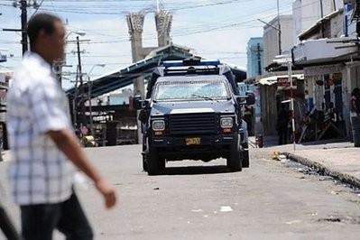 A police vehicle patrols the street in Kingston, Jamaica. A police vehicle patrols the street in Kingston, Jamaica.