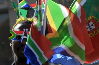 This photo taken on May 14, 2010 shows a street vendor in Johannesburg wearing the South African flag sun glasses and selling flags of the 32 countries taking part in the FIFA World Cup hosted by South Africa. AFP photo This photo taken on May 14, 2010 shows a street vendor in Johannesburg wearing the South African flag sun glasses and selling flags of the 32 countries taking part in the FIFA World Cup hosted by South Africa. AFP photo
