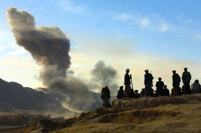 In this Nov. 19, 2001 file photo, Northern Alliance soldiers watch as U.S. air strikes pound Taliban positions in Kunduz province near the town of Khanabad, Afghanistan. In this Nov. 19, 2001 file photo, Northern Alliance soldiers watch as U.S. air strikes pound Taliban positions in Kunduz province near the town of Khanabad, Afghanistan.