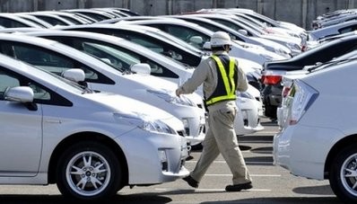 A worker walks between newly assembled Toyota vehicles at its plant in Aichi Prefecture. AFP file A worker walks between newly assembled Toyota vehicles at its plant in Aichi Prefecture. AFP file