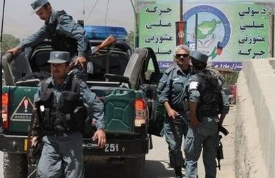 Afghan policemen arrive at a checkpoint near a sign promoting the 'peace jirga' in Kabul. AFP photo Afghan policemen arrive at a checkpoint near a sign promoting the 'peace jirga' in Kabul. AFP photo