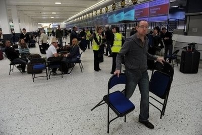 Staff hand out folding chairs to passengers as they wait for information at Manchester Airport, in northwest England after it was closed because of an Icelandic ash cloud in May. AFP file Staff hand out folding chairs to passengers as they wait for information at Manchester Airport, in northwest England after it was closed because of an Icelandic ash cloud in May. AFP file