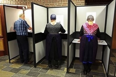 Women in traditional dresses vote in general elections in Staphorst. AFP photo Women in traditional dresses vote in general elections in Staphorst. AFP photo