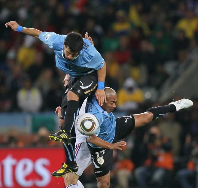 Uruguay's defender Mauricio Victorino (up) fights for the ball during their Group A first round 2010 World Cup football match on June 11, 2010. AFP photo Uruguay's defender Mauricio Victorino (up) fights for the ball during their Group A first round 2010 World Cup football match on June 11, 2010. AFP photo
