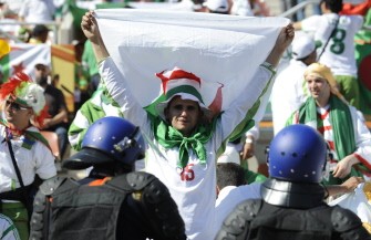 An Algeria fan holds up a flag before the Group C first round 2010 World Cup football match Algeria versus Slovenia on June 13, 2010. An Algeria fan holds up a flag before the Group C first round 2010 World Cup football match Algeria versus Slovenia on June 13, 2010.