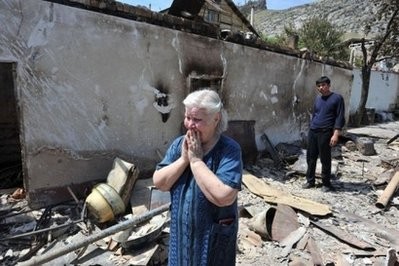 An ethnic Uzbek woman cries as she stands near the wreckage of her burned-out home in Osh. AFP photo An ethnic Uzbek woman cries as she stands near the wreckage of her burned-out home in Osh. AFP photo