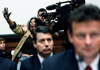 Protester Diane Wilson is escorted from the hearing room Protester Diane Wilson is escorted from the hearing room