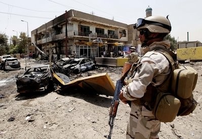 An Iraqi Army soldier stands guard at the site of a car bomb attack in Baghdad, Iraq, Sunday, June 20, 2010. An Iraqi Army soldier stands guard at the site of a car bomb attack in Baghdad, Iraq, Sunday, June 20, 2010.