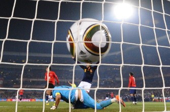 Chile's goalkeeper Claudio Bravo fails to pull of a shot from Spain's midfielder Andres Iniesta during the match on June 25, 2010. AFP Chile's goalkeeper Claudio Bravo fails to pull of a shot from Spain's midfielder Andres Iniesta during the match on June 25, 2010. AFP