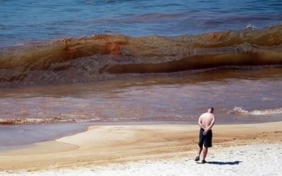 A man walks on Orange Beach, Alabama where oil can be seen in the waves on June 26. AFP A man walks on Orange Beach, Alabama where oil can be seen in the waves on June 26. AFP