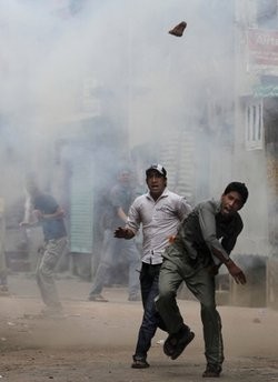 A Kashmiri throws a brick at policemen during a protest in Srinagar, India, Tuesday, June 29, 2010. A Kashmiri throws a brick at policemen during a protest in Srinagar, India, Tuesday, June 29, 2010.