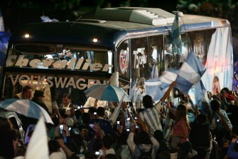 Argentine national soccer team supporters surround the bus which brings the players upon their arrival at Ezeiza airport in Buenos Aires, on July 4, 2010. AFP Argentine national soccer team supporters surround the bus which brings the players upon their arrival at Ezeiza airport in Buenos Aires, on July 4, 2010. AFP