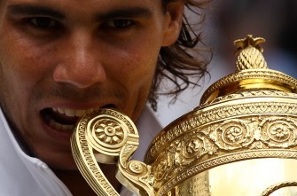 Nadal bites the trophy after beating Czech player Tomas Berdych on July 4, 2010. AFP Nadal bites the trophy after beating Czech player Tomas Berdych on July 4, 2010. AFP