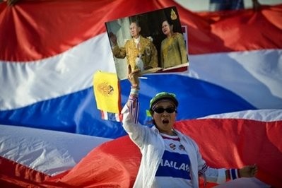 A Thai pro-government demonstrator holds a picture of King Bhumibol Adulyadej during a rally in Bangkok on May 6, 2010. AFP file A Thai pro-government demonstrator holds a picture of King Bhumibol Adulyadej during a rally in Bangkok on May 6, 2010. AFP file