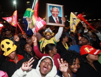 Football fans wave a portrait Nelson Mandela at the Durban Fan Fest as they watch on a giant screen the 2010 Football World Cup Final match between the Netherlands and Spain on July 11, 2010. AFP PHOTO Football fans wave a portrait Nelson Mandela at the Durban Fan Fest as they watch on a giant screen the 2010 Football World Cup Final match between the Netherlands and Spain on July 11, 2010. AFP PHOTO