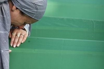 A Bosnian Muslim woman weeps near the coffin of her relative, a victim of the 1995 Srebrenica massacre, in Potocari 120 km northeast of Sarajevo, Bosnia, on Sunday, July 11, 2010 A Bosnian Muslim woman weeps near the coffin of her relative, a victim of the 1995 Srebrenica massacre, in Potocari 120 km northeast of Sarajevo, Bosnia, on Sunday, July 11, 2010