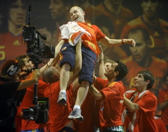 Andres Iniesta is carried by team mates on a stage set up for the Spanish team in Madrid on July 12, 2010 a day after they won the 2010 FIFA football World Cup. AFP Andres Iniesta is carried by team mates on a stage set up for the Spanish team in Madrid on July 12, 2010 a day after they won the 2010 FIFA football World Cup. AFP