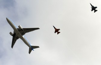 The plane carrying the Dutch national football team escorted by an orange F16 fighter jet (C) fly towards Schipol airport, in Amsterdam, on July 12, 2010. AFP The plane carrying the Dutch national football team escorted by an orange F16 fighter jet (C) fly towards Schipol airport, in Amsterdam, on July 12, 2010. AFP