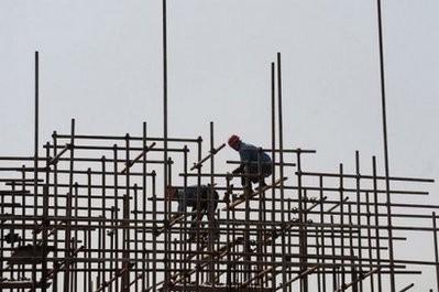 Chinese workers perch on scaffolding at a construction site in Hefei, central China's Anhui province. Chinese workers perch on scaffolding at a construction site in Hefei, central China's Anhui province.