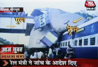 In an image grab taken from Aaj Tak television Indian bystanders and rescue officials crowd the scene of a train accident at Saithiya, some 250kms north of Kolkata on July 19, 2010. AFP In an image grab taken from Aaj Tak television Indian bystanders and rescue officials crowd the scene of a train accident at Saithiya, some 250kms north of Kolkata on July 19, 2010. AFP