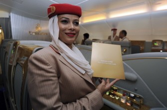 An air stewardess poses with a first class suite guide as she stands in the cabin of an Emirates A380 Airbus- the world's largest passenger aircraft - after touchdown at terminal T-3 of Indira Gandhi International Airport in New Delhi on July 15, 2010. AFP An air stewardess poses with a first class suite guide as she stands in the cabin of an Emirates A380 Airbus- the world's largest passenger aircraft - after touchdown at terminal T-3 of Indira Gandhi International Airport in New Delhi on July 15, 2010. AFP