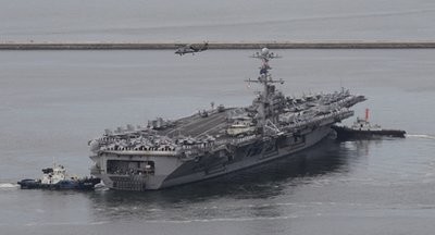 U.S. helicopter hovers above the U.S. aircraft carrier USS George Washington leaving for joint military exercises from Busan port in Busan, south of Seoul, South Korea, Sunday, July 25, 2010 U.S. helicopter hovers above the U.S. aircraft carrier USS George Washington leaving for joint military exercises from Busan port in Busan, south of Seoul, South Korea, Sunday, July 25, 2010