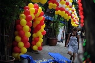 This photo taken on July 16, 2010 shows a tourist walking through a bar decorated with baloons for the weekend in Kuala Lumpur. AFP